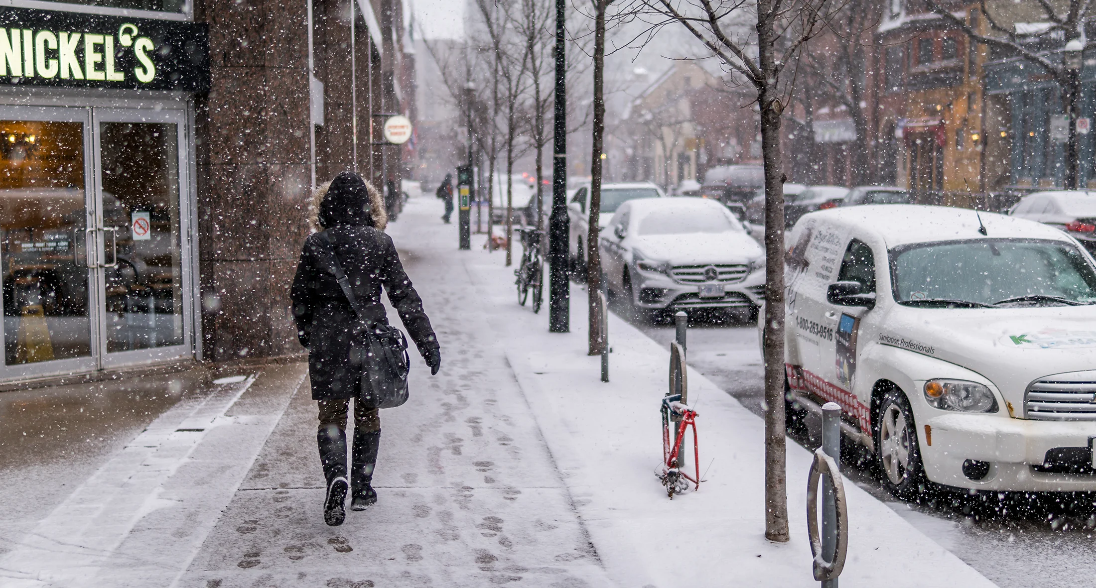Pedestrian in Toronto neighbourhood in the snow